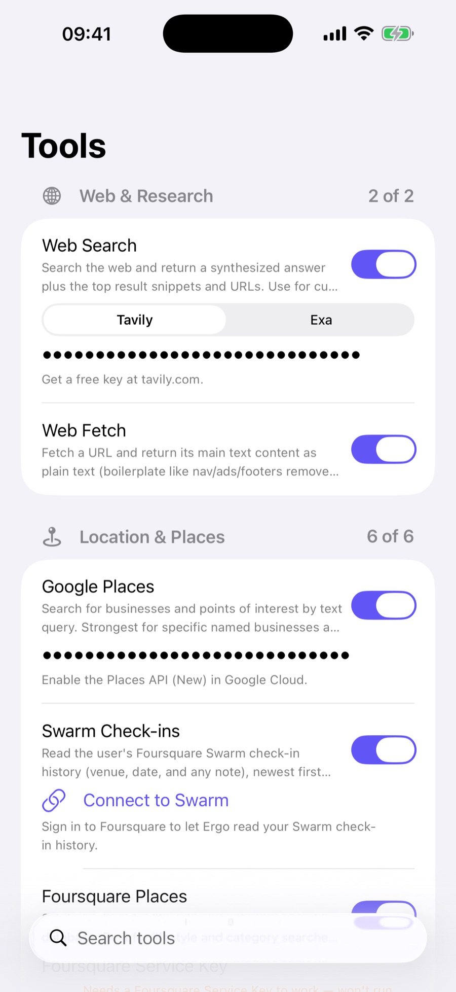 Ergo tools catalog grouped by category: Web & Research with Web Search (Tavily or Exa) and Web Fetch, and Location & Places with Google Places, Swarm check-ins, and Foursquare — each with an on/off toggle and its API key filled in